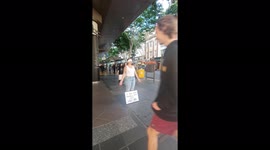 Aussie woman offers hugs for passersby 'going through hard times'
