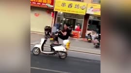 Chinese motorist spotted driving scooter without holding handlebars and with his legs casually crossed