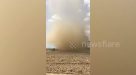 Dust devil rips through farmland in the Philippines