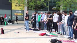 A group of Muslims pray whilst the free Palestine protest takes place. Outside BBC Studios, in Manchester