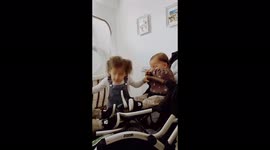 Sister dancing with her twin brothers . Twins trying to catch her hair