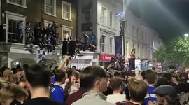 London's Chelsea fans jump on cars and sing on roofs as they celebrate Champions League win