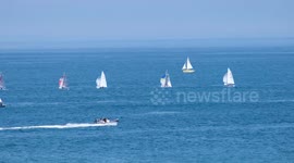 People out enjoying the sea on a sunny bank holiday monday at Polzeath, Cornwall