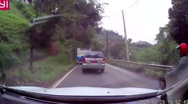 Rider and pillion passenger miraculously survive after crashing and skidding under truck in Malaysia