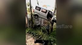 Minibus suspended mid-air between two trees after accident in China