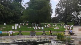 People Enjoy The Hot Summer Sun In The Italian Gardens In Kensington Gardens In London
