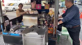 Man uses an old fashioned cannon-like cooking pan to make a puffed rice in Taiwan.