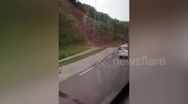 Motorists stranded after landslide debris blocks mountain road during tropical storm Choi-wan in the Philippines