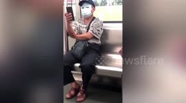 Chinese man uses masks to cover his whole face on train