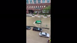 Vehicles struggle to drive through submerged streets as tropical storm hits Taiwan