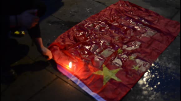 Chinese protest outside the Embassy in London and burn flag on anniversary of Tiananmen Square Massacre.