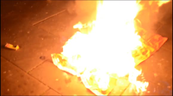 Flag burned outside London's Chinese Embassy  on Tiananmen Square Massacre anniversary