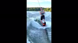 Dog proudly rides waves while wakeboarding with owner