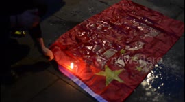 Demonstrators burn Chinese flag outside London's embassy on Tiananmen anniversary