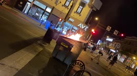 A dumpster burns after BLM protestors ignited it following the shooting death of Winston Smith