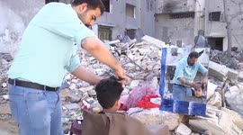 Palestinian barber sets up hair salon on ruins of his old business, destroyed by airstrikes
