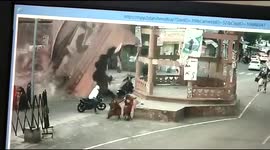 Motorists and pedestrians escape unhurt after temple entrance collapses on road in India