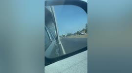 Shocked drivers watch overloaded truck travelling on road