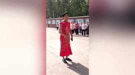 Male teacher wears traditional Chinese dress to encourage students before exam