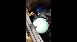 Indonesian firefighters rescue cat stuck at bottom of deep well