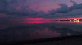 Beautiful pink skies sunrise over the calm peaceful waters of Lake Superior