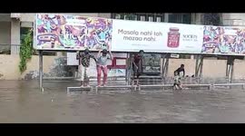 Mumbai residents dive into flooded streets as storm lashes city