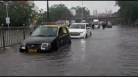 Motorists struggle to drive through submerged streets as flood hit Mumbai