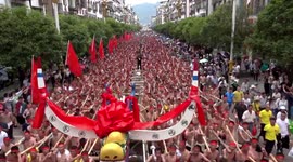 Hundreds carry world's largest wooden dragon boat along road during festival in China