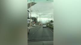 Roof flies off building and hits electricity wires during storm in central Thailand