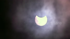 Partial Solar Eclipse breaks through the cloud above Birmingham, England