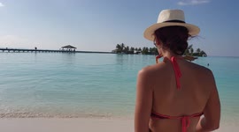 Newsflare Edit - Tourist walking onto a beach in the maldives