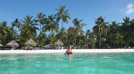 Tourist walking onto a beach in the maldives 6