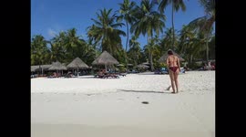 Tourist walking onto a beach in the maldives 9