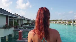 Tourist walking on the pier at the maldives water villa