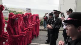 Red-robed protesters and pink boat seen at Extinction Rebellion's G-7 summit demonstration