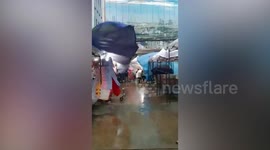 Storm blows away shop front canopy tent in Thailand