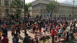 Poluce attempt to clear the road outside Downing Street as protesters await the results of the reopening debate