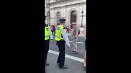 Elderly man calls London police officers 'scum' for walking past Cenotaph with masks on