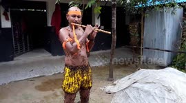 Hundreds of bees swarm Bangladeshi man's body as he plays flute