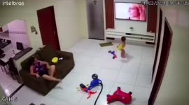 Startled toddler slams toy truck at TV