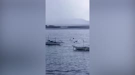 Waterspout forms off the coast near fishing boats in the Philippines