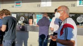 Fans present their proof of their full vaccination in order to get a wristband to enter the stadium