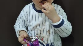 3-year-old boy getting messy after eating chocolate biscuits