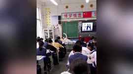 Teacher with bad back lies down as she gives lessons in China