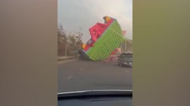 Bouncy castles blows onto road during storm in Laos