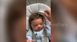Newborn baby stuns family after being born with a thick head of hair