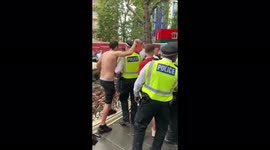 Police removing Scottish football fans from the Leicester Square fountain …. They have added some soap to create bubbles