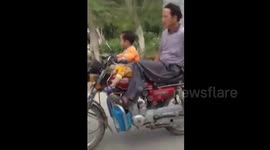 Toddler taught to ride motorbike in China