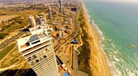 Paraglider soars over skyscrapers in Israel