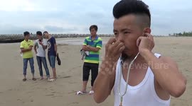 Man inflates a tyre using his ears